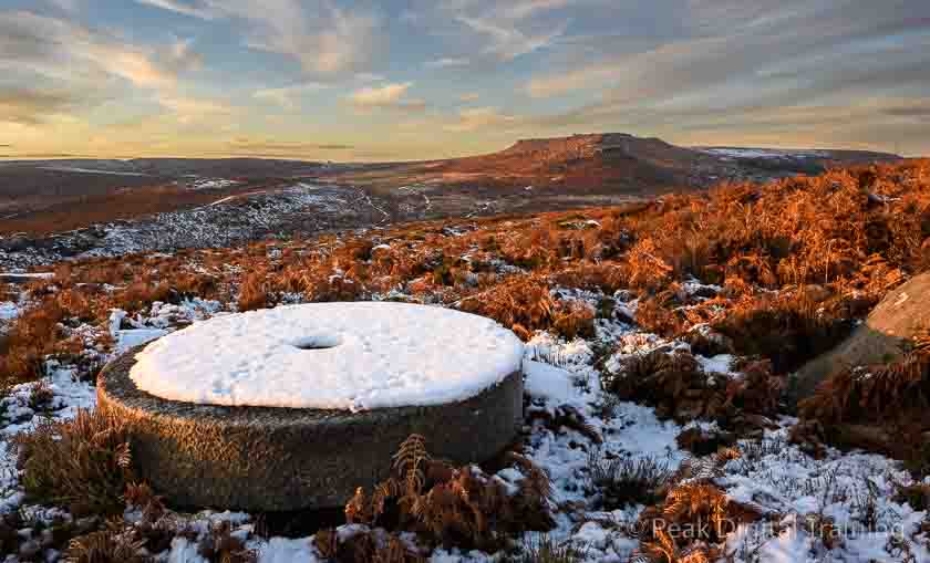 Millstone in the snow in the Derbyshire Peak District. Photo © Chris James