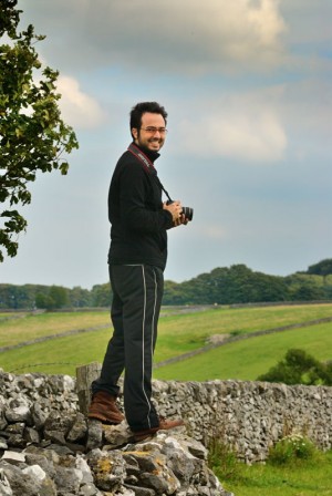 A photographer standing on a drystone wall on a digital camera course in the Derbyshire Peak District